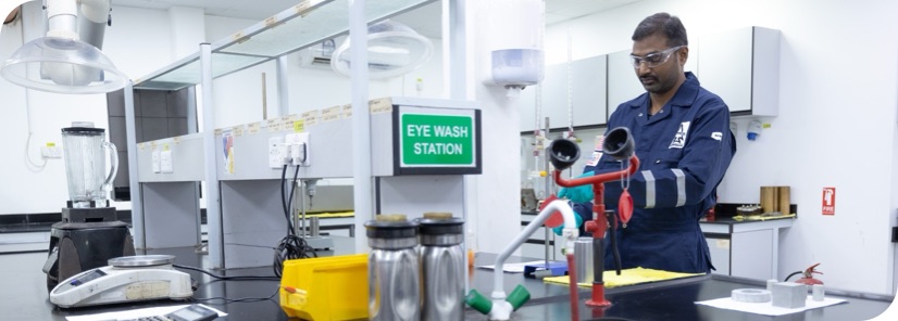 A Superior Cementing technician working at a lab station on new chemical formulas