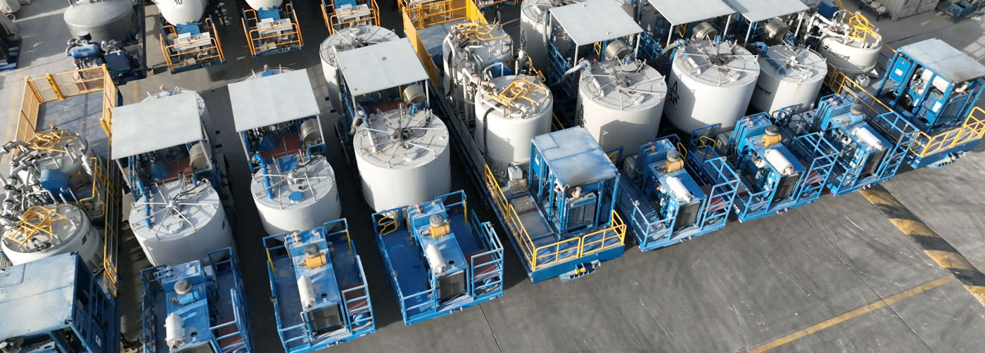 Batch mixers lined up in a parking lot at the Superior Cementing Kuwait facility