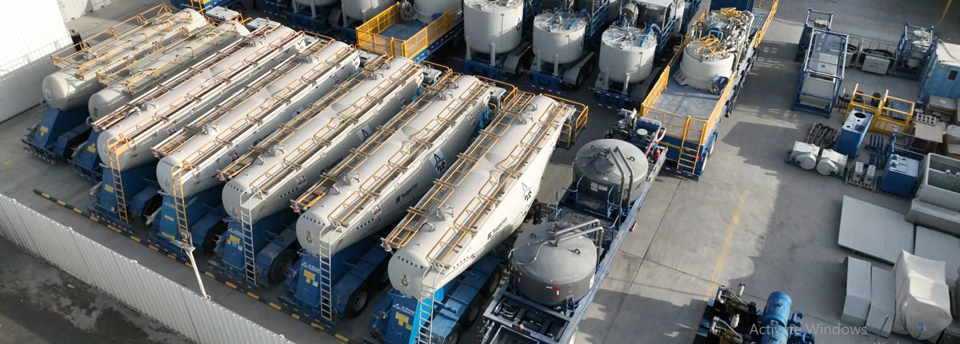 Cement bulkers parked in a row on a lot at the Superior Cementing Kuwait facility